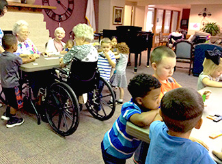 schoolchildren mingle with nursing home residents