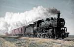 Colorized photograph showing train and cars moving on the tracks of Oklahoma